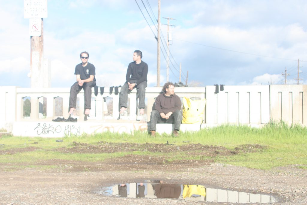 Sean, Ashes, and Wes wait for a train in Modesto, California